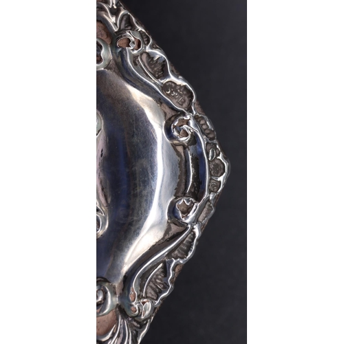 241 - A small silver mounted freestanding photograph frame with raised floral and leaf decoration, 13cm hi... 