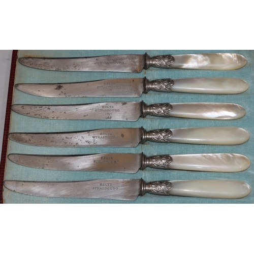 244 - A set of 6 Mother of Pearl handled butter knives in red leather case, a set of 6 porcelain handled b... 