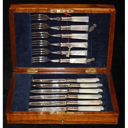 245 - A set of 6 silver plated fruit knives and forks with Mother of Pearl handles, in oak case