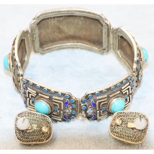 252 - An Oriental silver gilt 5-panel bracelet with turquoise centres  surrounded by turquoise and blue en... 