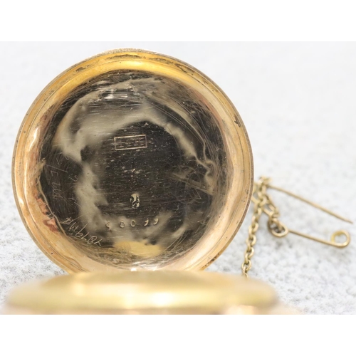 256 - A 14ct gold small fob watch with chased floral decoration and Roman numerals (starts but then stops)... 