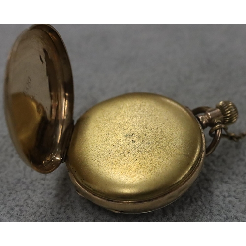 256 - A 14ct gold small fob watch with chased floral decoration and Roman numerals (starts but then stops)... 