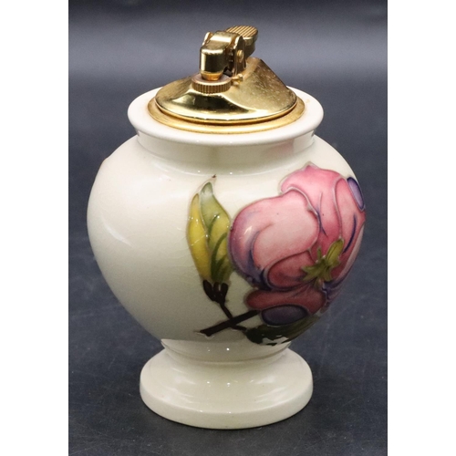 26 - A Moorcroft round bulbous shaped table lighter on cream ground with multi-coloured floral and leaf d... 