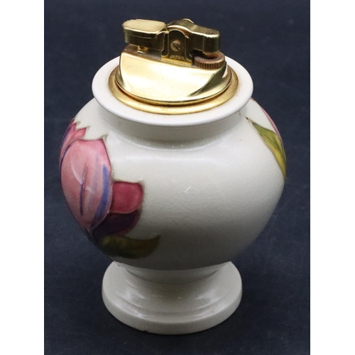 26 - A Moorcroft round bulbous shaped table lighter on cream ground with multi-coloured floral and leaf d... 