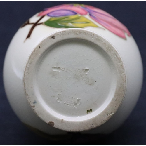 26 - A Moorcroft round bulbous shaped table lighter on cream ground with multi-coloured floral and leaf d... 