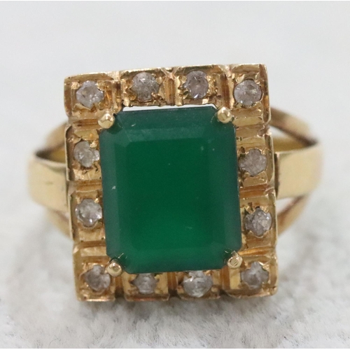 263 - A Continental gold rectangular shaped ring set with centre green stone surrounded by clear stones, S... 