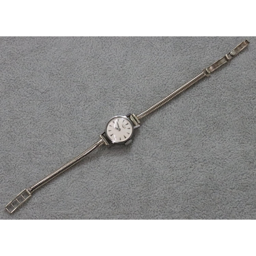 266 - A ladies' Longines circular wristwatch with 9ct white gold strap bracelet, overall weight 14.9 grams... 