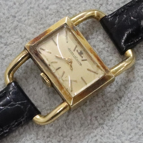 267 - An 18ct gold ladies' Jaeger Le Coultre wristwatch with rectangular shaped dial and open shoulders, l... 