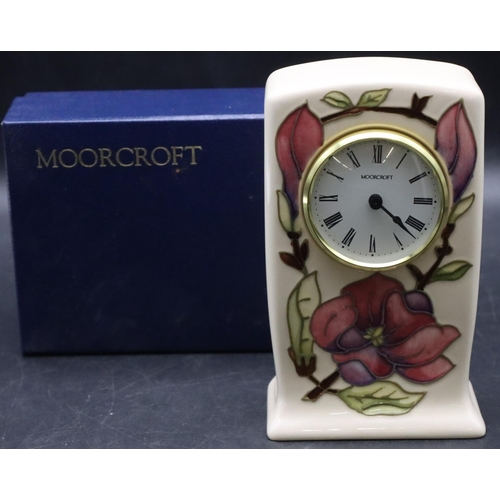 27 - A Moorcroft rectangular shaped timepiece with white enamel dial and Roman numerals on cream ground w... 