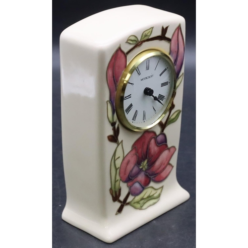 27 - A Moorcroft rectangular shaped timepiece with white enamel dial and Roman numerals on cream ground w... 