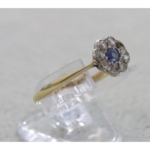 287 - An 18ct gold small cluster ring set with centre sapphire surrounded by small diamond chips (1 diamon... 