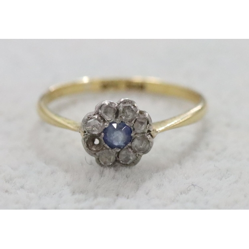 287 - An 18ct gold small cluster ring set with centre sapphire surrounded by small diamond chips (1 diamon... 