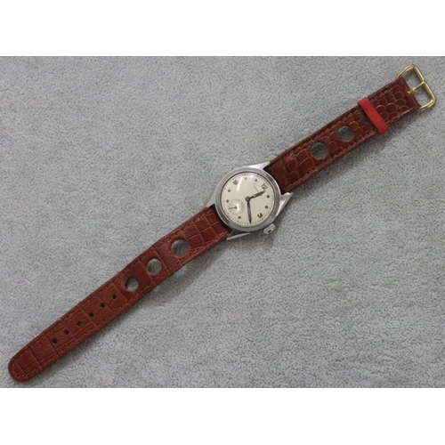 292 - A Leonidas circular wristwatch with seconds dial and leather strap bracelet (working)