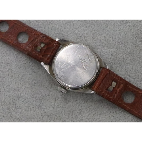 292 - A Leonidas circular wristwatch with seconds dial and leather strap bracelet (working)