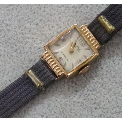 293 - An 18ct gold ladies' Mithra square faced wristwatch with leather strap bracelet (working but sticks)