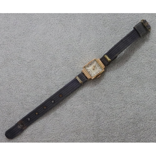 293 - An 18ct gold ladies' Mithra square faced wristwatch with leather strap bracelet (working but sticks)