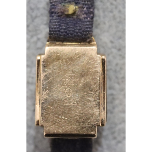 293 - An 18ct gold ladies' Mithra square faced wristwatch with leather strap bracelet (working but sticks)