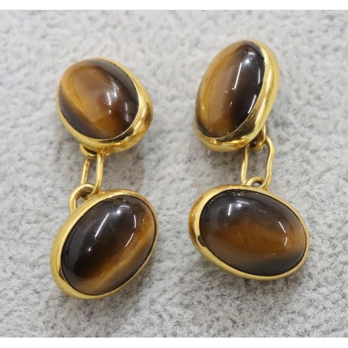 300 - A pair of 9ct gold oval Tiger's Eye cufflinks, 8.8 grams gross