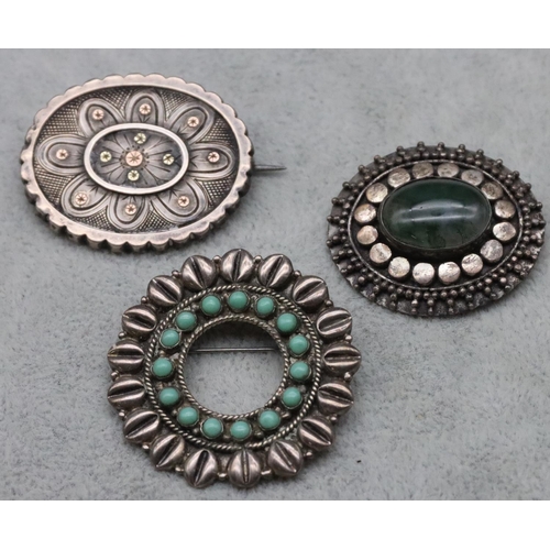 308 - A Mexican silver scallop shaped brooch set with turquoise and 2 silver oval brooches (3)