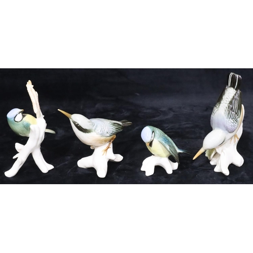 31 - 4 various Continental china figures of perched birds, largest 15.5cm high (4)