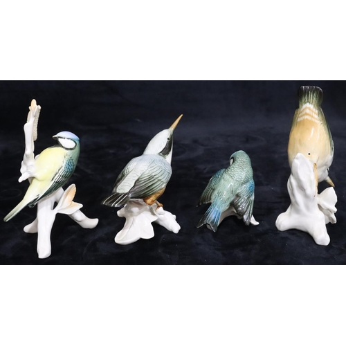 31 - 4 various Continental china figures of perched birds, largest 15.5cm high (4)