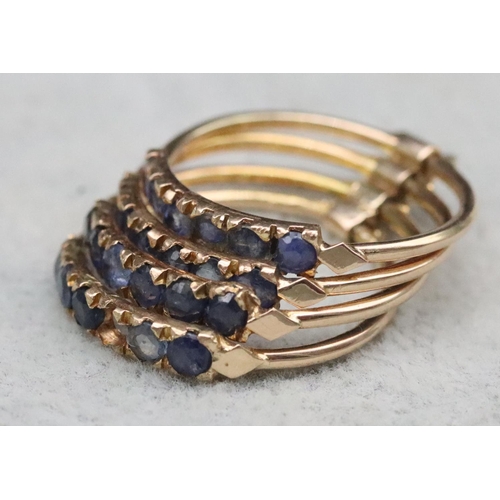 323 - A set of 4 entwined gold rings, each set with 6 blue stones (1 stone missing), Size O, 4.7 grams gro... 