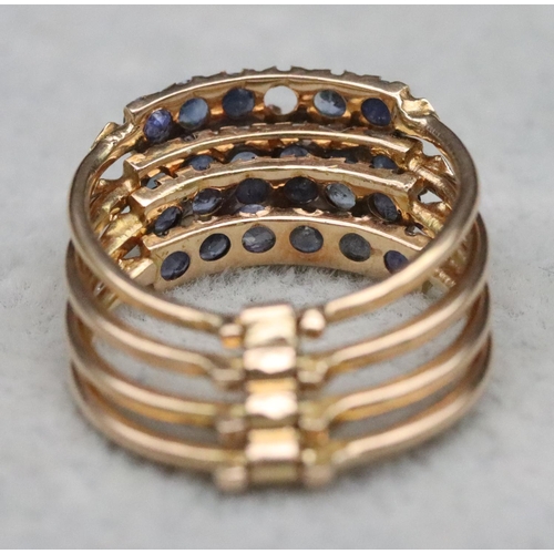 323 - A set of 4 entwined gold rings, each set with 6 blue stones (1 stone missing), Size O, 4.7 grams gro... 