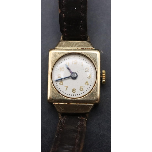 335 - A ladies' small 9ct gold wristwatch with circular dial with Arabic numerals and leather strap