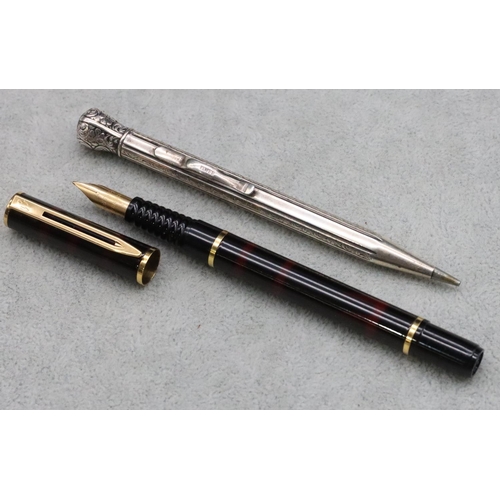 346 - A Continental 835 silver coloured metal propelling pencil with bright cut decoration and a Waterman ... 