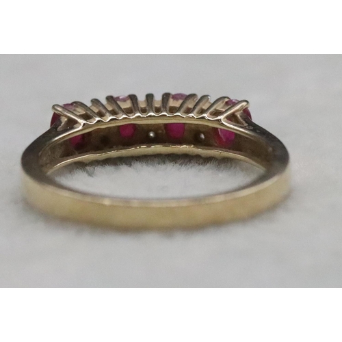 365 - A 9ct gold ladies' ring set with 4 rubies interspersed by 6 small diamonds, Size N/O, 2.6 grams