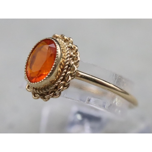 369 - A 9ct gold ladies' ring set with orange stone, Size L, 1.5 grams