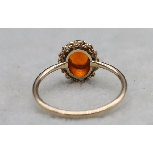 369 - A 9ct gold ladies' ring set with orange stone, Size L, 1.5 grams