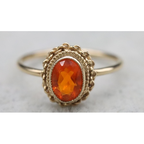 369 - A 9ct gold ladies' ring set with orange stone, Size L, 1.5 grams