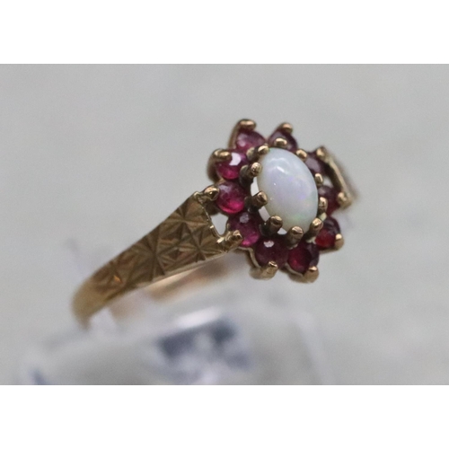 372 - A 9ct gold oval ring set with opal surrounded by garnets, Size N, 1.4 grams gross