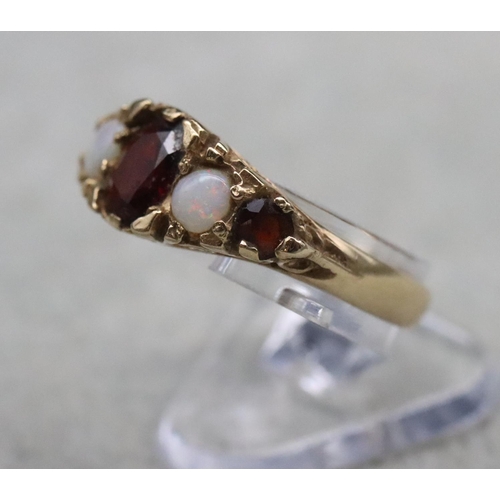 391 - A 9ct gold ladies' ring set with 3 garnets interspersed by 2 opals, Size O/P, 2.8 grams gross