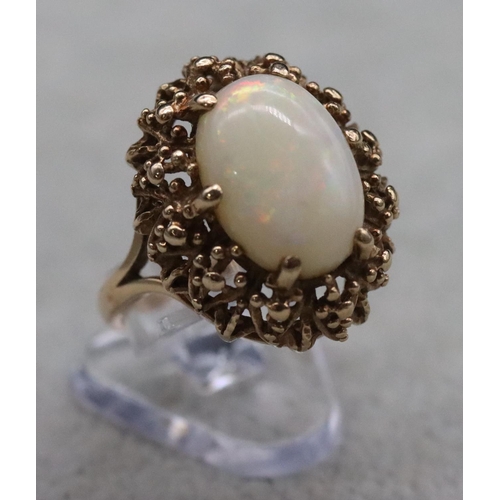 392 - A 9ct gold ladies' oval cluster ring set with centre opal, Size O/P, 6.2 grams gross