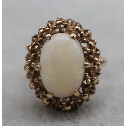 392 - A 9ct gold ladies' oval cluster ring set with centre opal, Size O/P, 6.2 grams gross