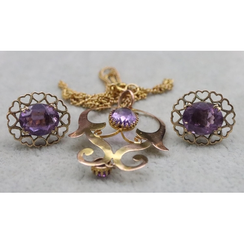 394 - A 9ct gold drop pierced pendant set with 2 amethysts, with 9ct gold linked chain, 3.4 grams gross an... 