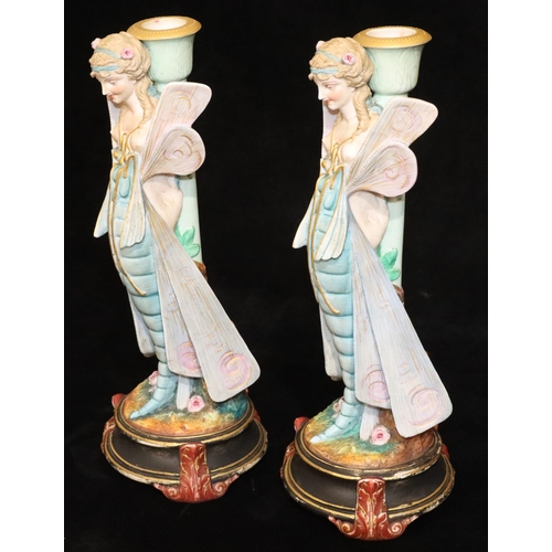 4 - A pair of Paris china figured candlesticks in the form of fairies, on round black bases, 34.5cm high... 