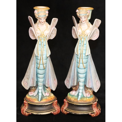 4 - A pair of Paris china figured candlesticks in the form of fairies, on round black bases, 34.5cm high... 