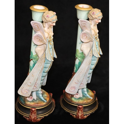 4 - A pair of Paris china figured candlesticks in the form of fairies, on round black bases, 34.5cm high... 