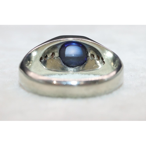 404 - An 18ct white gold cabachon cushion cut blue stone ring mounted with small diamonds to shoulders, Si... 