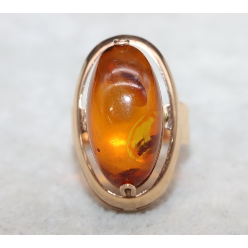 405 - A Continental gold ring with oval amber, Size M/N, 7.2 grams gross