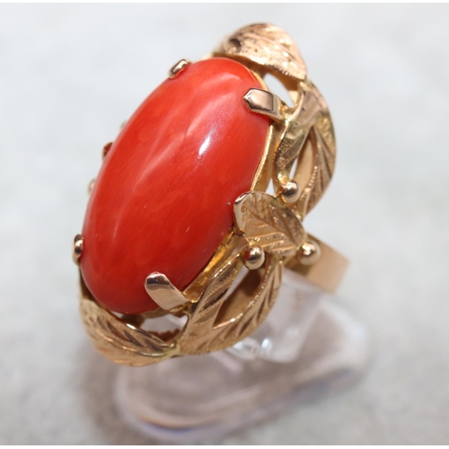 406 - A continental gold ladies' ring set with red coral with pierced decoration, Size M/N, 7.5 grams gros... 