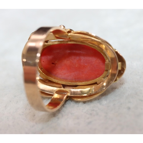 406 - A continental gold ladies' ring set with red coral with pierced decoration, Size M/N, 7.5 grams gros... 