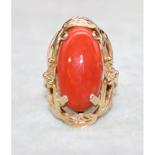 406 - A continental gold ladies' ring set with red coral with pierced decoration, Size M/N, 7.5 grams gros... 