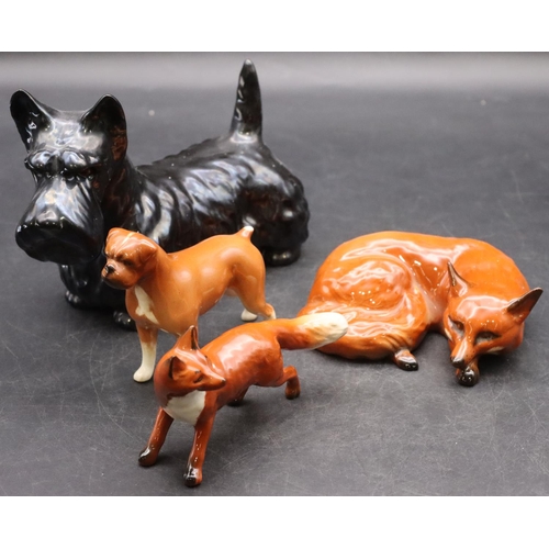 41 - A Beswick figure of a relaxing fox, 11cm wide, another Beswick figure of a fox, a Beswick figure of ... 