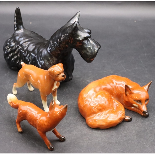 41 - A Beswick figure of a relaxing fox, 11cm wide, another Beswick figure of a fox, a Beswick figure of ... 