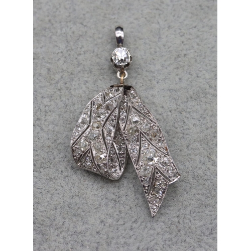 410 - A platinum Art Deco style ribbon shaped drop pendant mounted with allover diamonds, 4.3cm high, 4.3 ... 