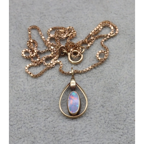 413 - A gold oval black opal pendant with square 9ct gold chain, 4.9 grams gross